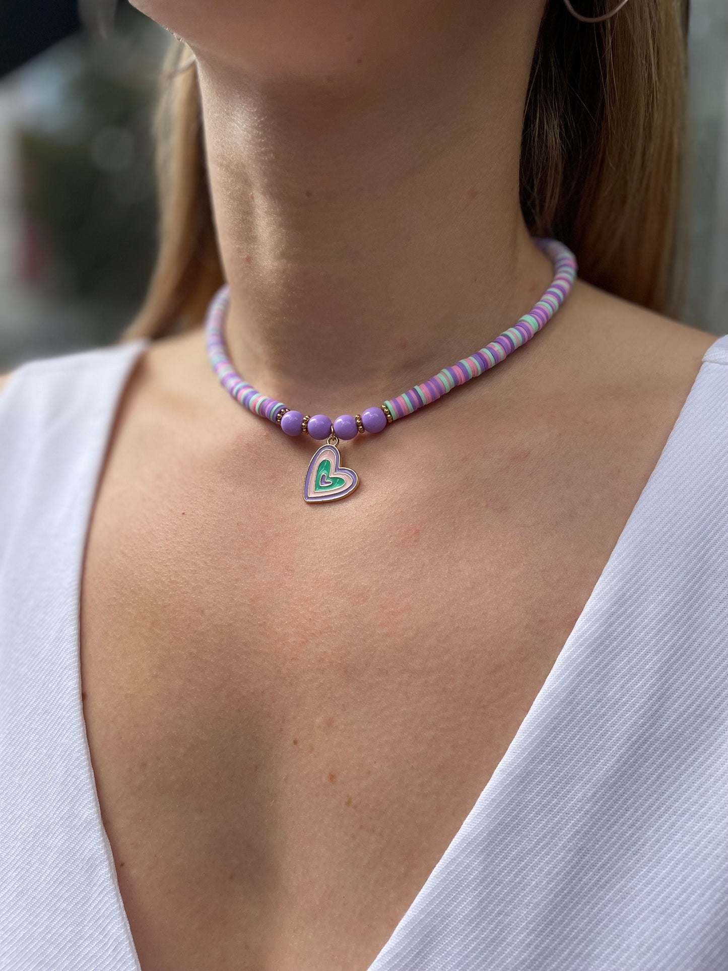 Purple beaded necklace with a heart charm