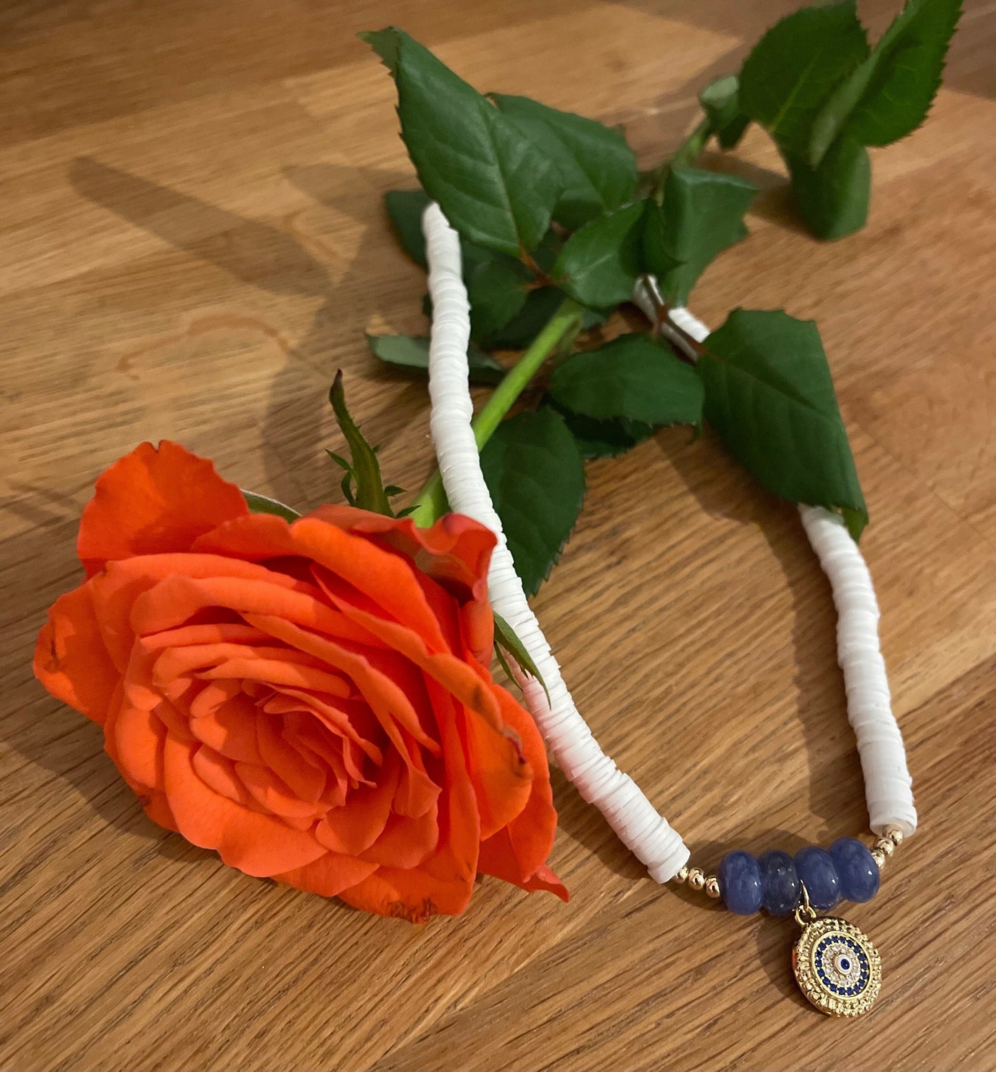 White blue evil eye necklace with a charm perfect for summer