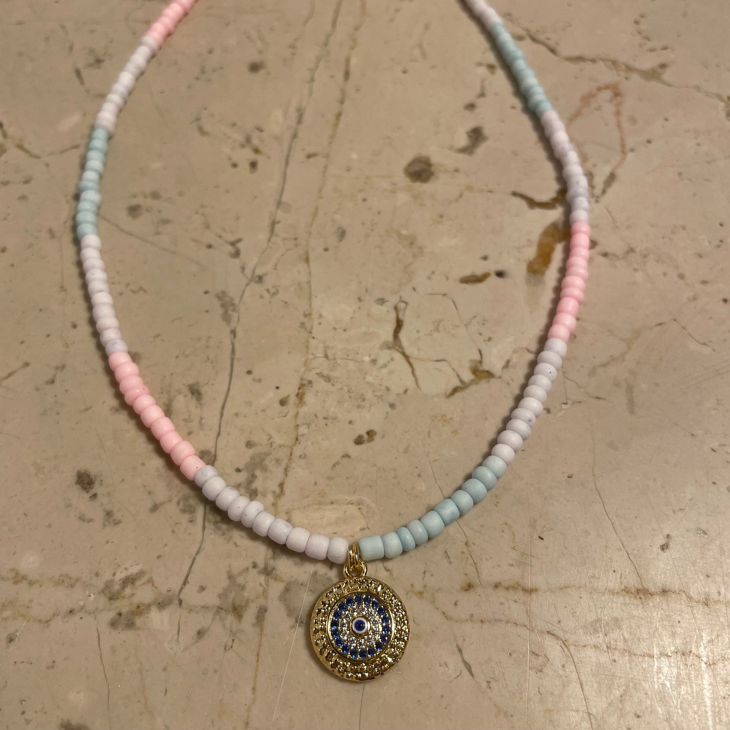 Ombre thin beaded necklace in pastel colors and evil eye charm