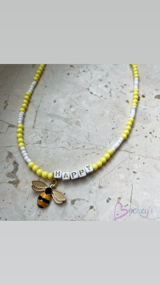 Yellow be(e) happy necklace, beaded letter necklace with a charm